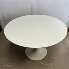 a white round table sitting on top of a floor