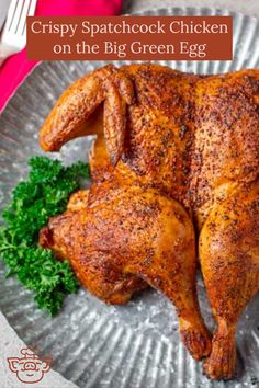 a whole chicken sitting on top of a metal plate with parsley next to it