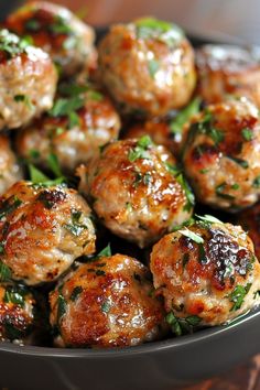 meatballs with herbs in a bowl on a table