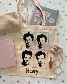 a harry potter tote bag with the faces of two men on it, along with other items