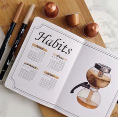 a recipe book with an image of a coffee pot on it next to markers and pencils