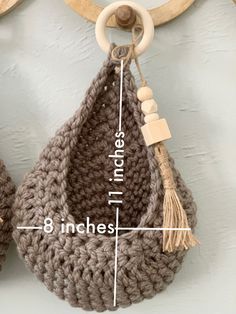 a crocheted purse hanging from a hook on a wall with measurements for it