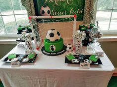 a soccer themed dessert table with cupcakes and snacks