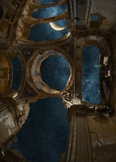 looking up at the night sky and stars from inside an old building with water in it