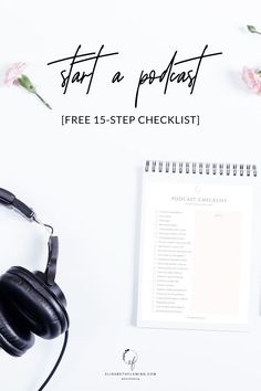 headphones, notepad and pen on top of a white desk with pink flowers