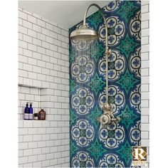 a shower head and hand held shower faucet in front of a tiled wall