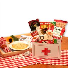 a wooden tray filled with food sitting on top of a checkered tablecloth covered table