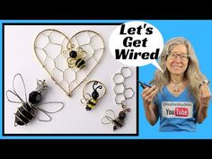 a woman holding a cell phone next to some wire and metal items that look like bees