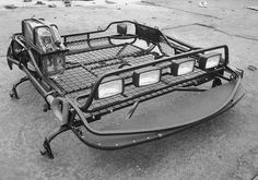 a black and white photo of a motorcycle trailer on the street with no one around it