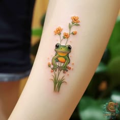 a small frog with flowers on its back leg is sitting in front of a woman's legs