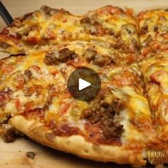 a pizza sitting on top of a cutting board covered in cheese and meat toppings