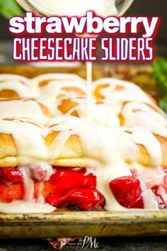 strawberry cheesecake sliders on a baking sheet with icing being drizzled over them