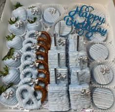 a box filled with lots of blue and silver items next to a happy birthday sign