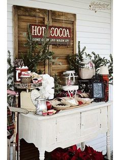 an american farmhouse style christmas display in front of a wooden sign with hot cocoa on it