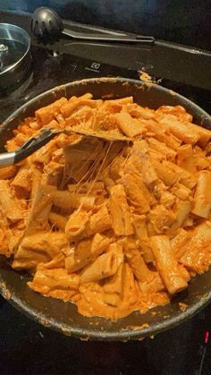 a pan filled with food sitting on top of a stove