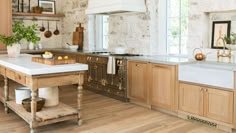 a large kitchen with wooden cabinets and white counter tops, along with an island in the middle