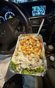 a car dashboard with a tray of food in it