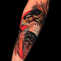 an arm with a bird on it and red, black and grey colors in the background