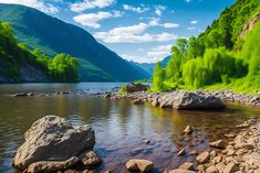 a river with rocks in the water and green trees on both sides, surrounded by mountains