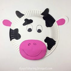 a paper plate with a cow's face on it and black spots around the nose