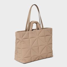 This Kate Tote Handbag from A New Day™ in a solid color showcases an unstructured silhouette with a geometric quilted finish for a chic, textured look and it goes well with any of your outfits. The interior accessories pocket, zip pocket and exterior side pockets help keep your belongings organized. Designed with a magnetic closure, this stylish tote handbag is easy to carry with double shoulder and grab handles. A New Day™: Style that goes wherever you do. Everyday Textured Tote Bag, Chic Textured Travel Bag, Modern Quilted Shoulder Bag For Everyday, Versatile Quilted Tote Bag, Modern Quilted Everyday Shoulder Bag, Textured Tote Shoulder Bag For Travel, Textured Travel Tote Shoulder Bag, Versatile Quilted Beige Bag, Textured Rectangular Travel Bag