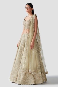 Gold organza lehenga with gota embroidery in geometric and floral motifs. Comes with a corset shape blouse and a scalloped dupatta.
Component: 3
Pattern: Embroidery
Type Of Work: Gota, Pearls, Dabka, Zardozi and Sequins
Neckline: Sweetheart
Sleeve Type: Cap sleeves
Fabric: Lehenga and Blouse: Organza; Dupatta: Net
Color: Gold
Other Details: 
Tie-up tassel back
Hand embroidery
Occasion: Destination Wedding,Bride - Aza Fashions Wedding Saree Set Made Of Lace, Wedding Saree Set In Lace, Lace Saree Set For Wedding, Lace Dupatta Wedding Sets, Lace Wedding Set With Dupatta, Fitted Lace Choli With Sheer Dupatta, Fitted Sets With Sheer Dupatta For Ceremony, Festive Lace Wedding Sets, Fitted Choli With Dupatta For Ceremony