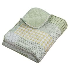 a green and yellow quilted blanket on a white background