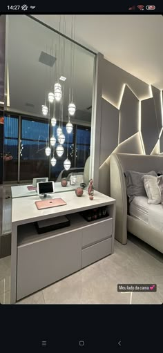 a bedroom with a large mirror and lights hanging from the ceiling