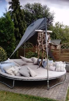 an outdoor day bed with pillows on it