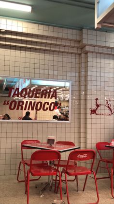 the interior of a restaurant with red chairs and tables in front of a sign that reads, tabaleria orinoco