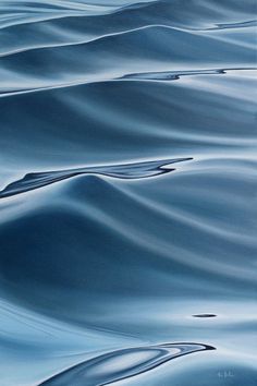 an abstract painting of blue water with ripples