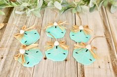 four ceramic ornaments are sitting on a wooden table