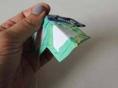 a person holding an origami piece in their hand