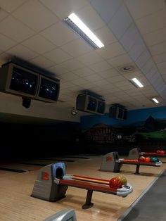 several bowling lanes lined up in an indoor bowling alley