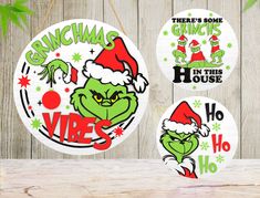 grinchma in this house christmas ornament hanging on a wooden wall with green and red decorations