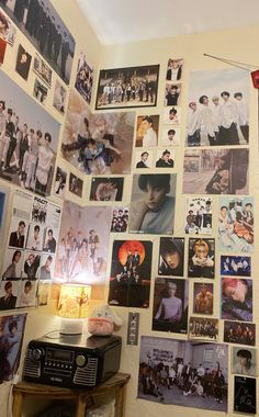 a wall covered in pictures and posters with a radio