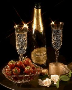 champagne and strawberries are sitting on a table