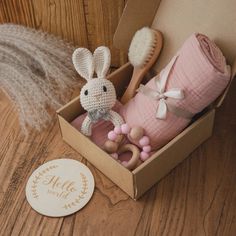 a little bunny in a box with some items on the floor next to it,