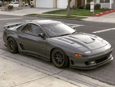 a gray sports car parked on the side of the road