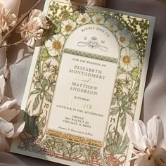 an ornate wedding card with flowers on it