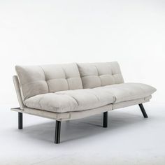 a white couch sitting on top of a metal frame