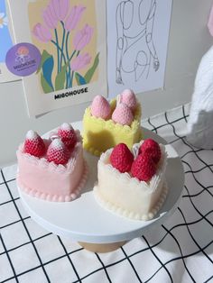 two cakes with raspberries on top sitting on a table next to each other