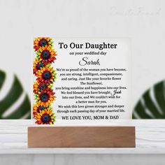 a card with the words, to our daughter on your wedding day and sunflowers