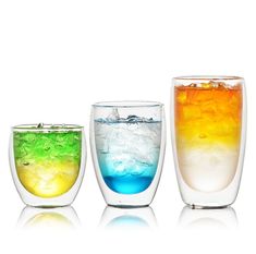 three glasses filled with different colored liquids