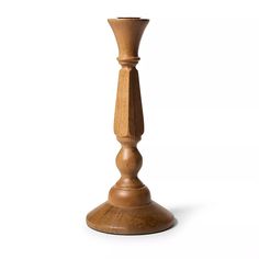 a tall wooden candle holder on a white background with clippings to the bottom