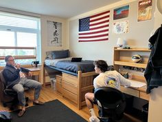 two people sitting in chairs in a bedroom