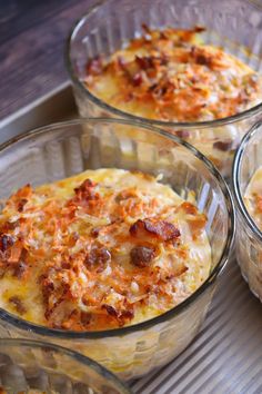 three glass bowls filled with food on top of a tray