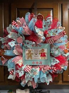 a christmas wreath is hanging on the wall in front of a kitchen counter with cookies and candies