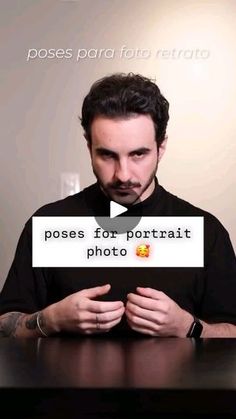 a man sitting at a table with a sign in front of him that says poses for portrait photo