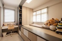 a teddy bear sitting on top of a bed in a bedroom